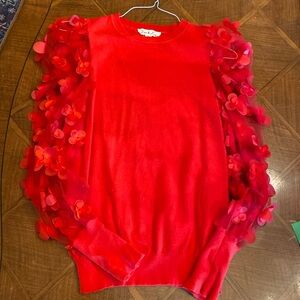 Precious red sweater with cut out flower arm detail. S